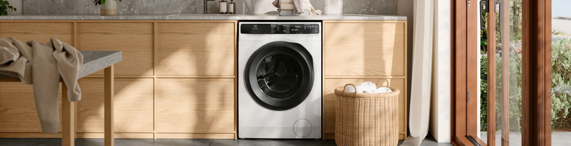 Electrolux washing machine in a bright laundry room.